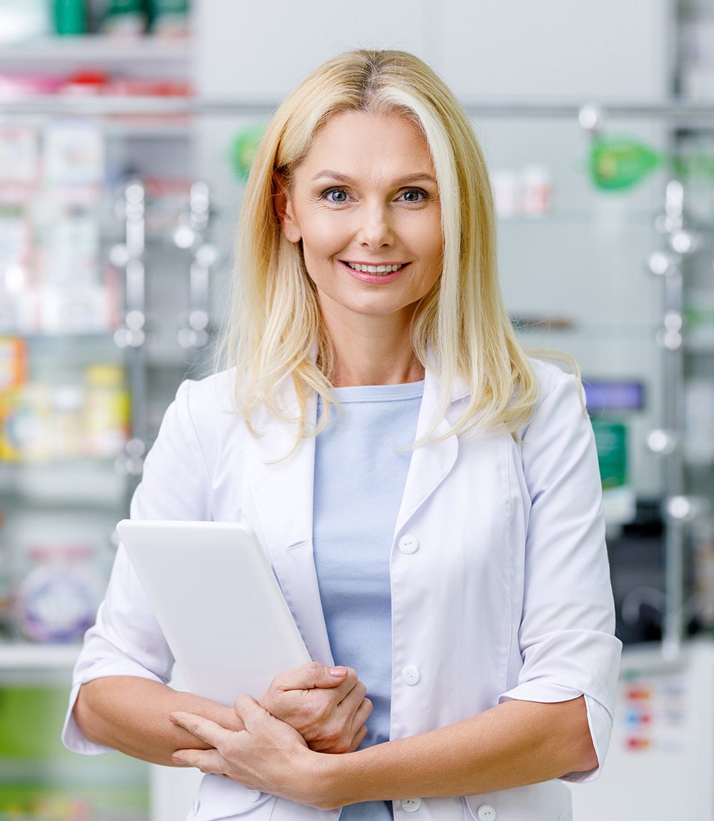 female pharmacist in white coat holding digital ta F5GU928 About Us